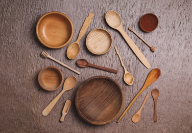 Photo of Set of clean cooking utensils on wooden table, flat lay