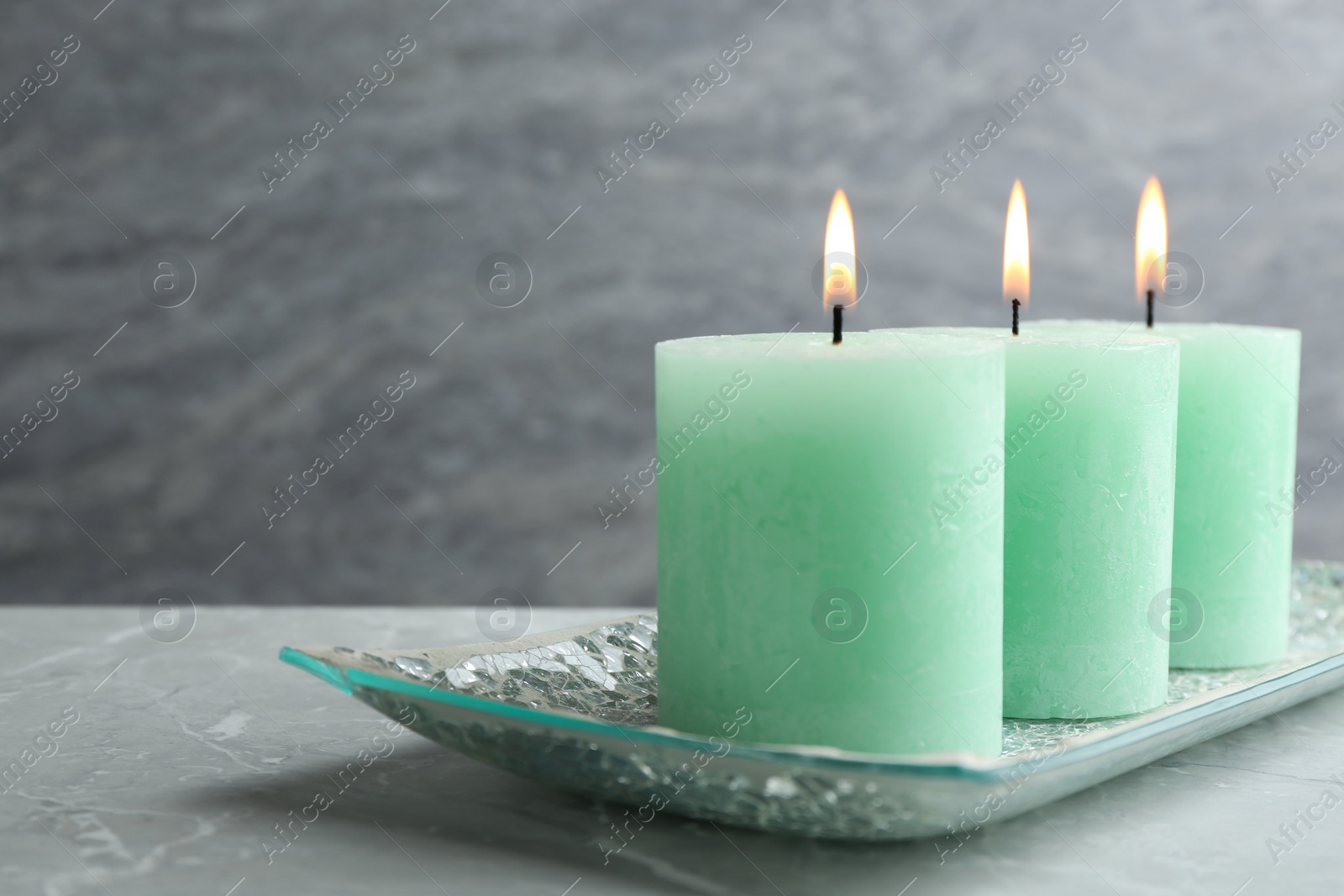 Photo of Composition with three burning candles on table. Space for text