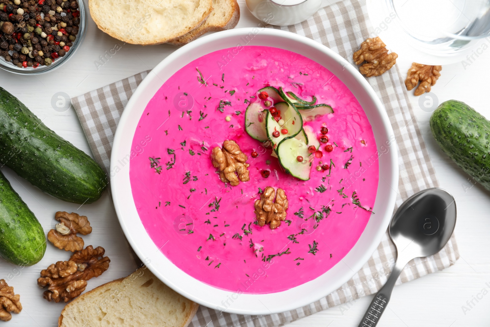 Photo of Delicious cold summer beet soup on white wooden table, flat lay