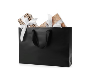 Photo of Paper shopping bag with handles full of gift boxes on white background. Mock up for design