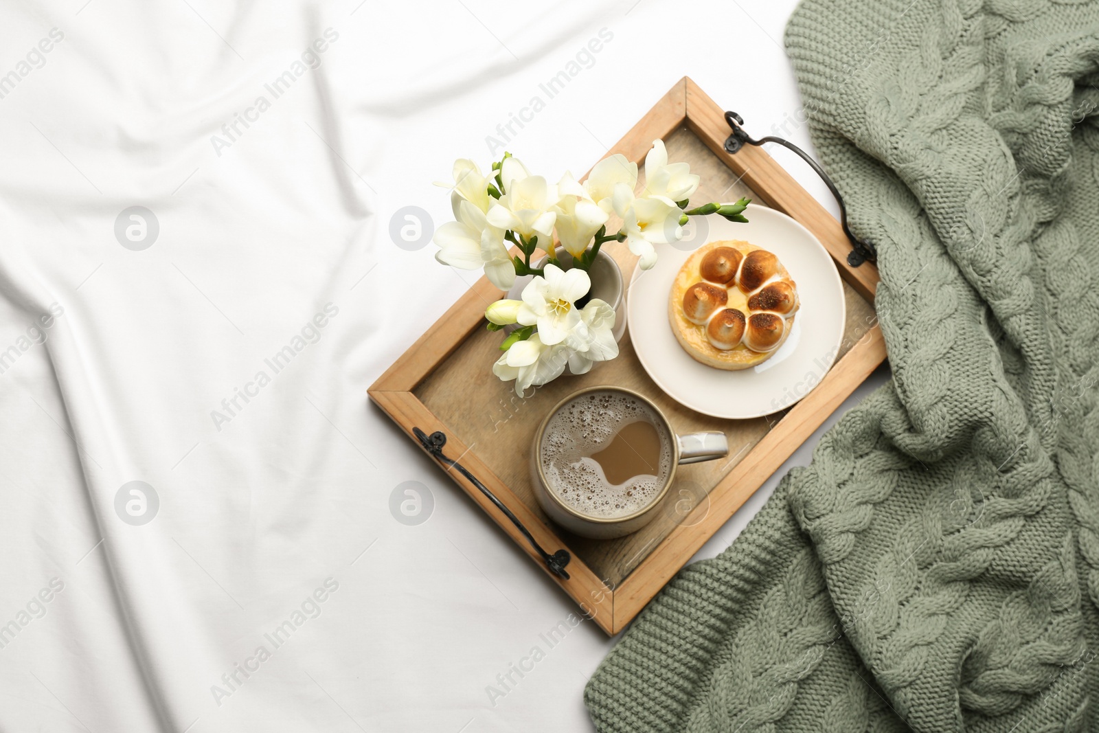 Photo of Flat lay composition with coffee and warm plaid on white bedsheet