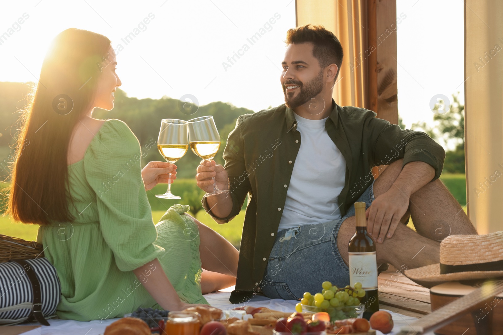 Photo of Romantic date. Beautiful couple having picnic outdoors on sunny day