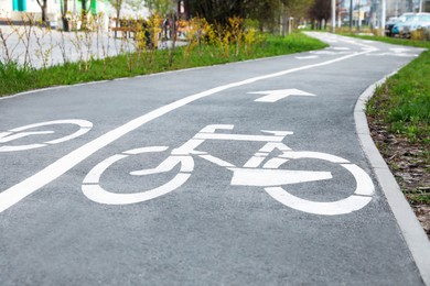 Photo of Two way bicycle lane with white markings on asphalt in city