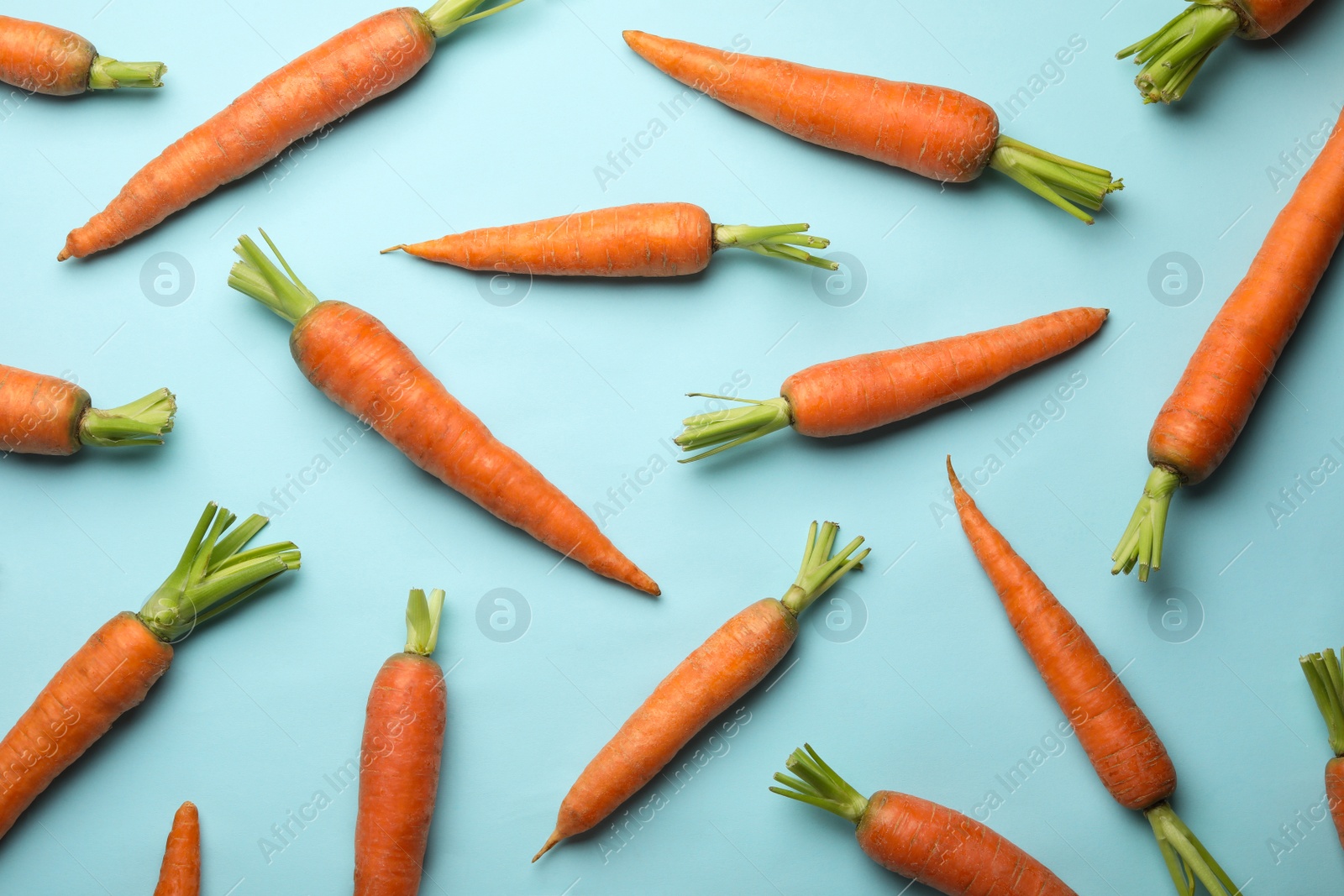 Photo of Flat lay composition with fresh carrots on color background