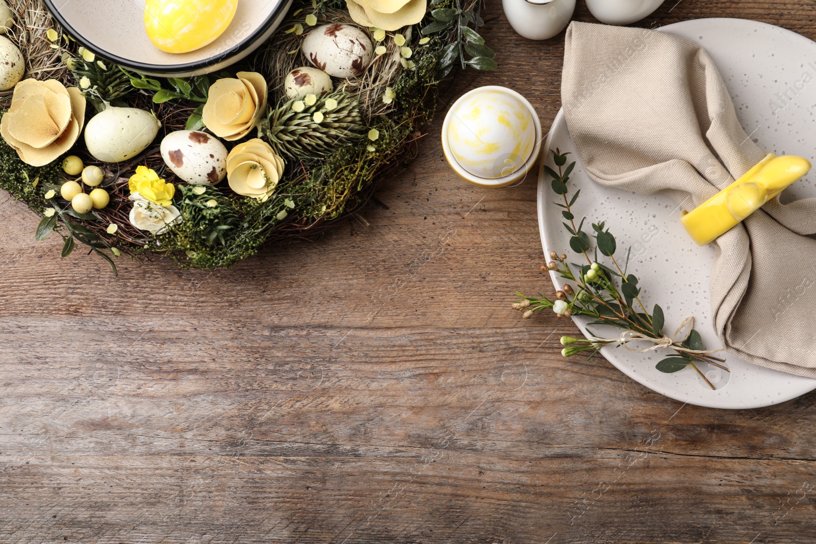 Photo of Rustic Easter table setting with eggs and floral decor, flat lay. Space for text