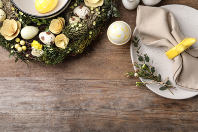 Rustic Easter table setting with eggs and floral decor, flat lay. Space for text