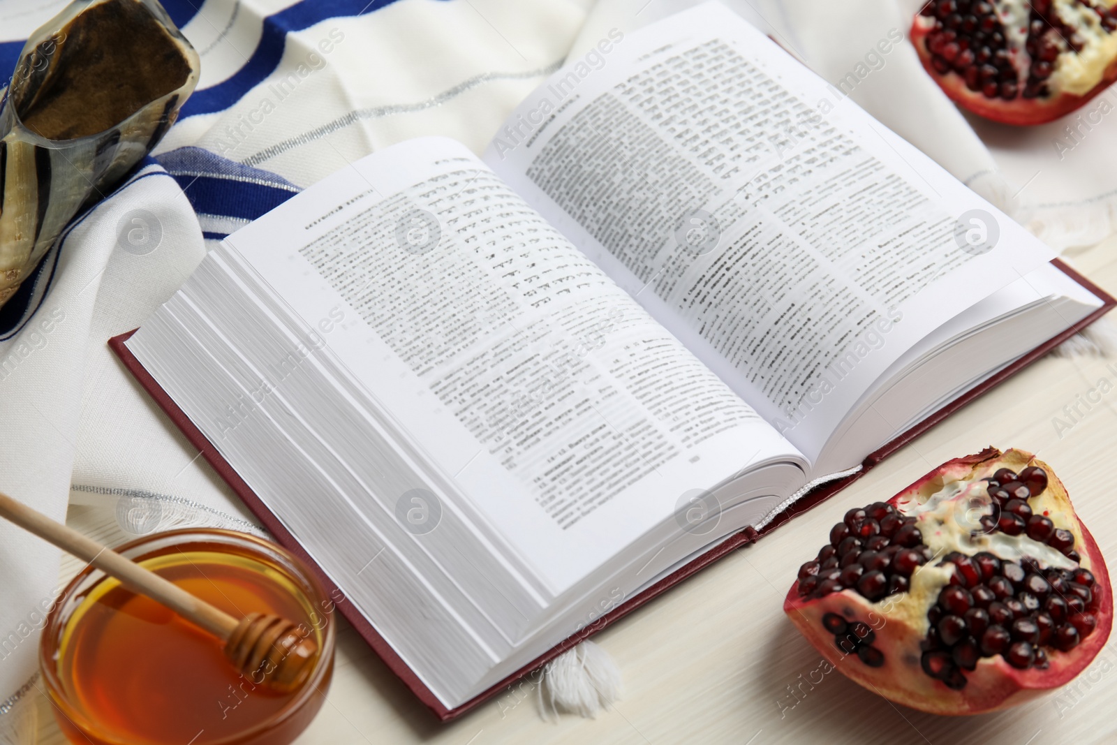 Photo of Composition with Rosh Hashanah holiday symbols on white wooden table