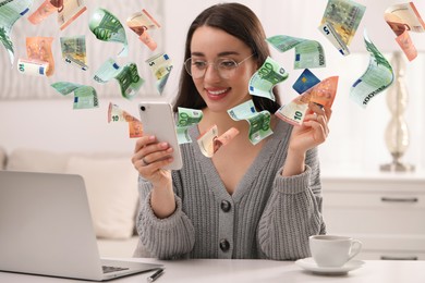Image of Online payment. Woman with credit card buying something using mobile phone at home. Euro banknotes flying out of gadget as process of money transaction