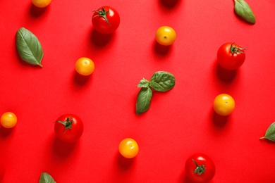Photo of Flat lay composition with ripe cherry tomatoes and basil leaves on color background