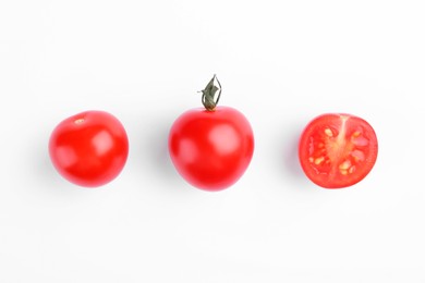 Photo of Whole and cut ripe tomatoes on white background, top view