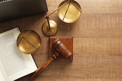 Photo of Law concept. Gavel, book and scales of justice on wooden table, flat lay. Space for text