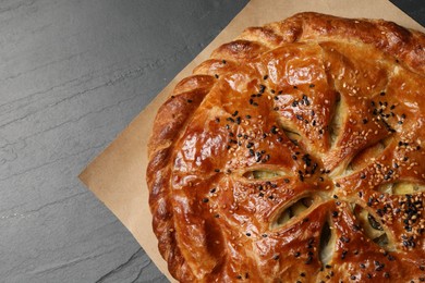 Photo of Tasty homemade pie with filling on grey table, top view. Space for text