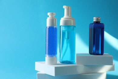 Photo of Set of luxury cosmetic products on light blue background. Space for text