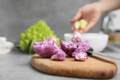 Photo of Fresh purple cauliflower on grey table, closeup