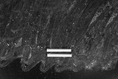 Photo of Chalk on dirty blackboard with space for text