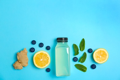 Photo of Flat lay composition with delicious natural lemonade on color background