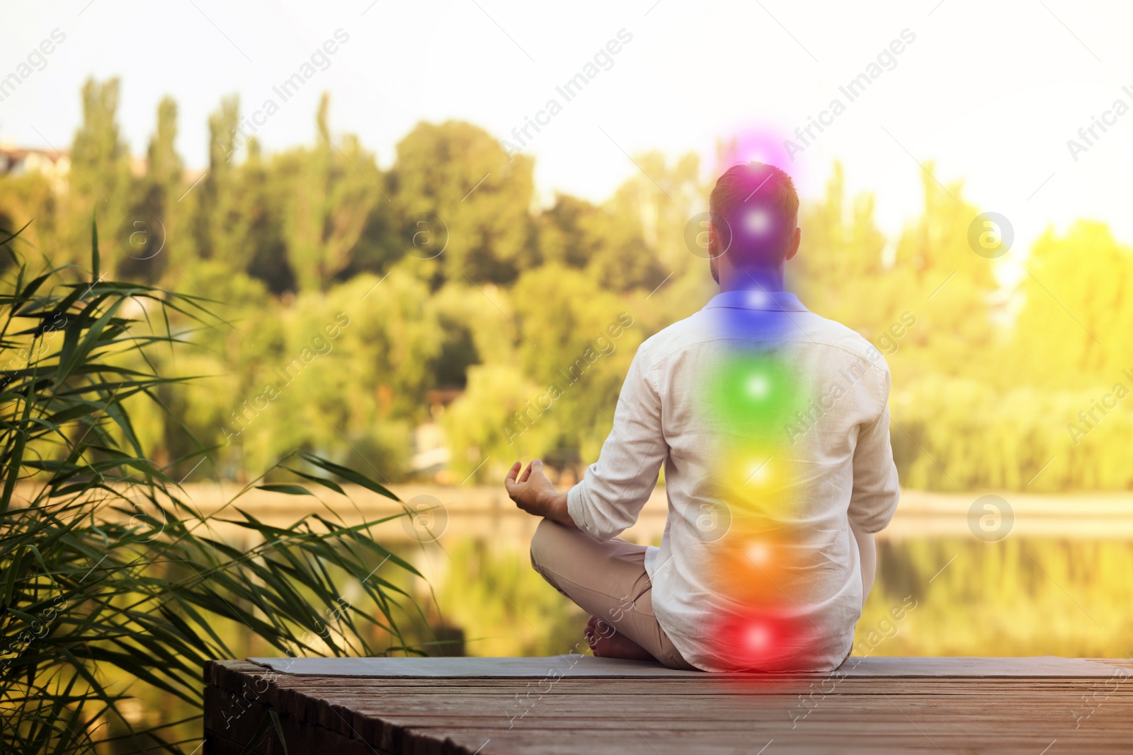 Image of Man meditating on wooden pier near river, back view. Scheme of seven chakras, illustration