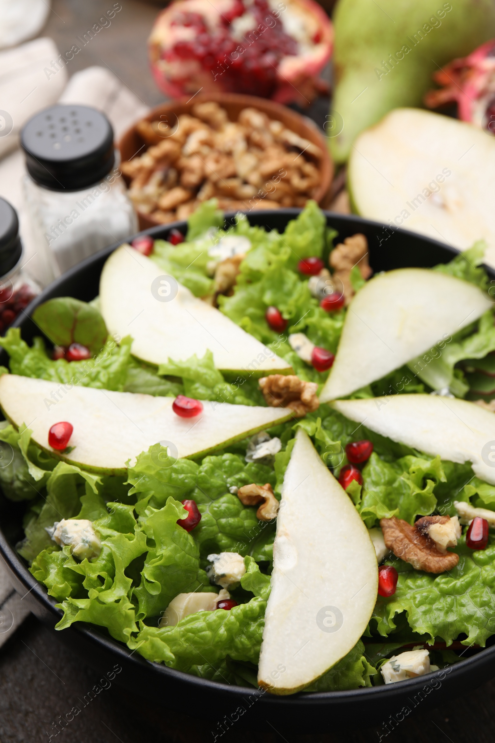 Delicious pear salad in bowl on table, closeup Photo of Delicious pear salad in bowl on table, closeup