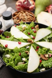Photo of Delicious pear salad in bowl on table, closeup