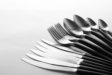 Photo of Forks, knives and spoons on white background