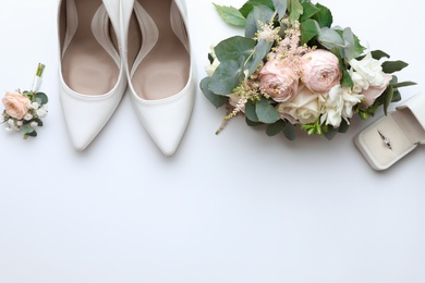 Photo of Composition with wedding high heel shoes on white background, top view