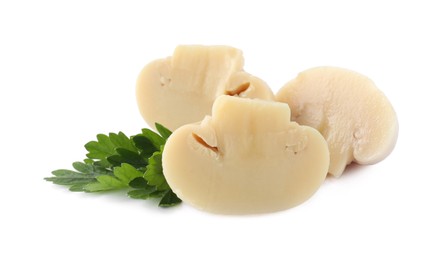 Photo of Cut marinated mushrooms and parsley isolated on white