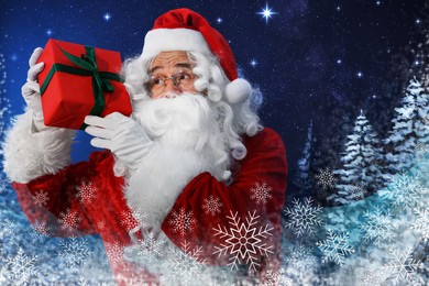 Image of Santa Claus with gift in snowy winter forest. Christmas magic