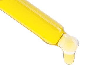 Photo of Dripping tincture from pipette on white background