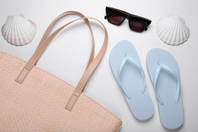 Flat lay composition with beach accessories on white background