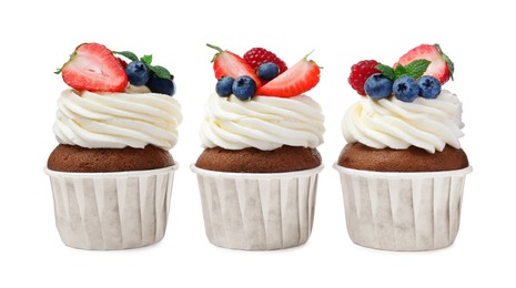 Photo of Sweet cupcakes with fresh berries on white background