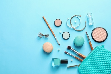 Photo of Makeup products with cosmetic bag on color background