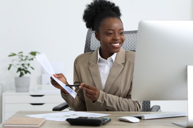 Photo of Professional accountant having video chat via computer at wooden desk in office