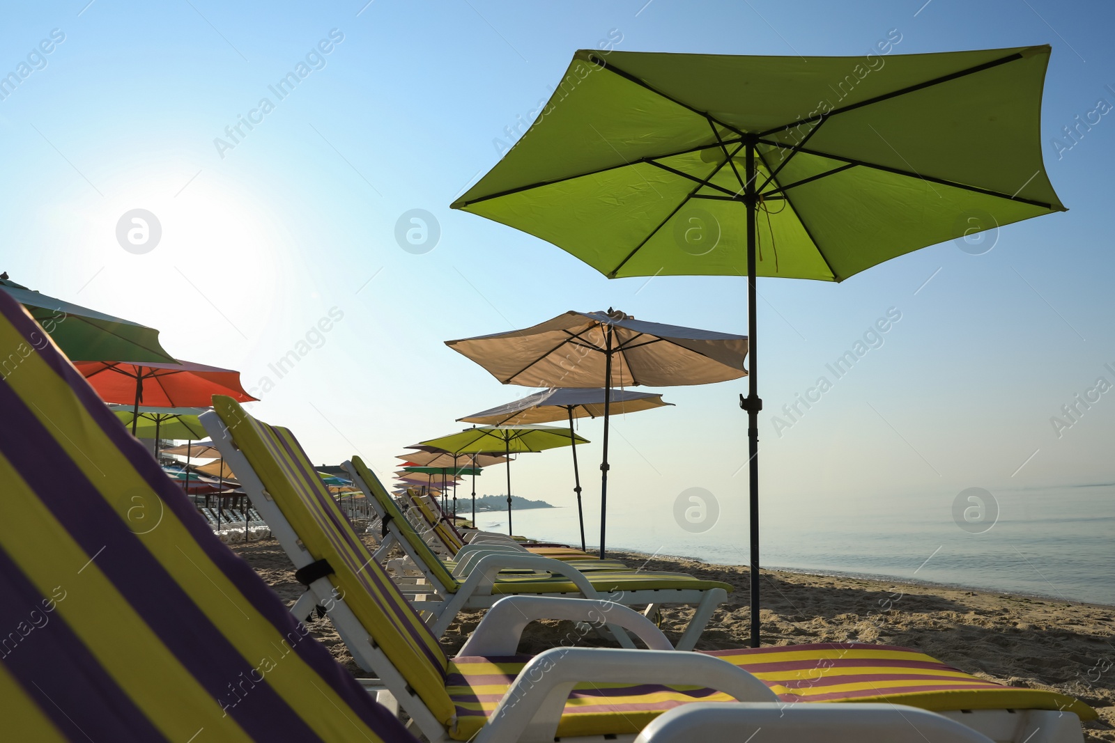 Photo of Many beach umbrellas and sunbeds at resort