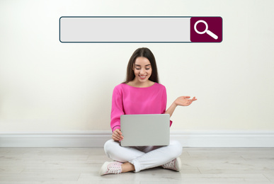Image of Search bar of internet browser and woman with laptop sitting on floor near light wall indoors