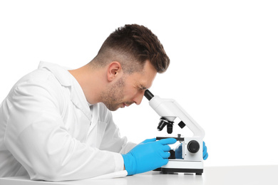 Photo of Scientist using modern microscope at table isolated on white. Medical research