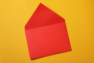 Photo of Red letter envelope on orange background, top view