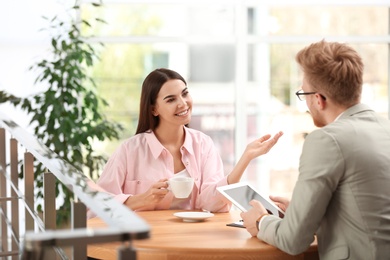 Insurance agent working with young woman in office