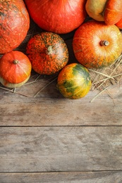 Photo of Orange pumpkins on wooden background, flat lay composition with space for text. Autumn holidays