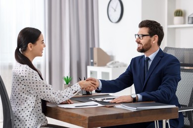 Photo of Lawyer shaking hands with client in office