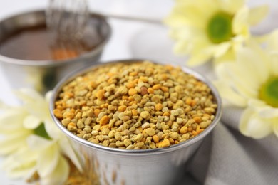 Photo of Fresh bee pollen granules on table, closeup
