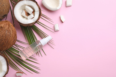 Photo of Flat lay composition with coconut oil on pink background, space for text