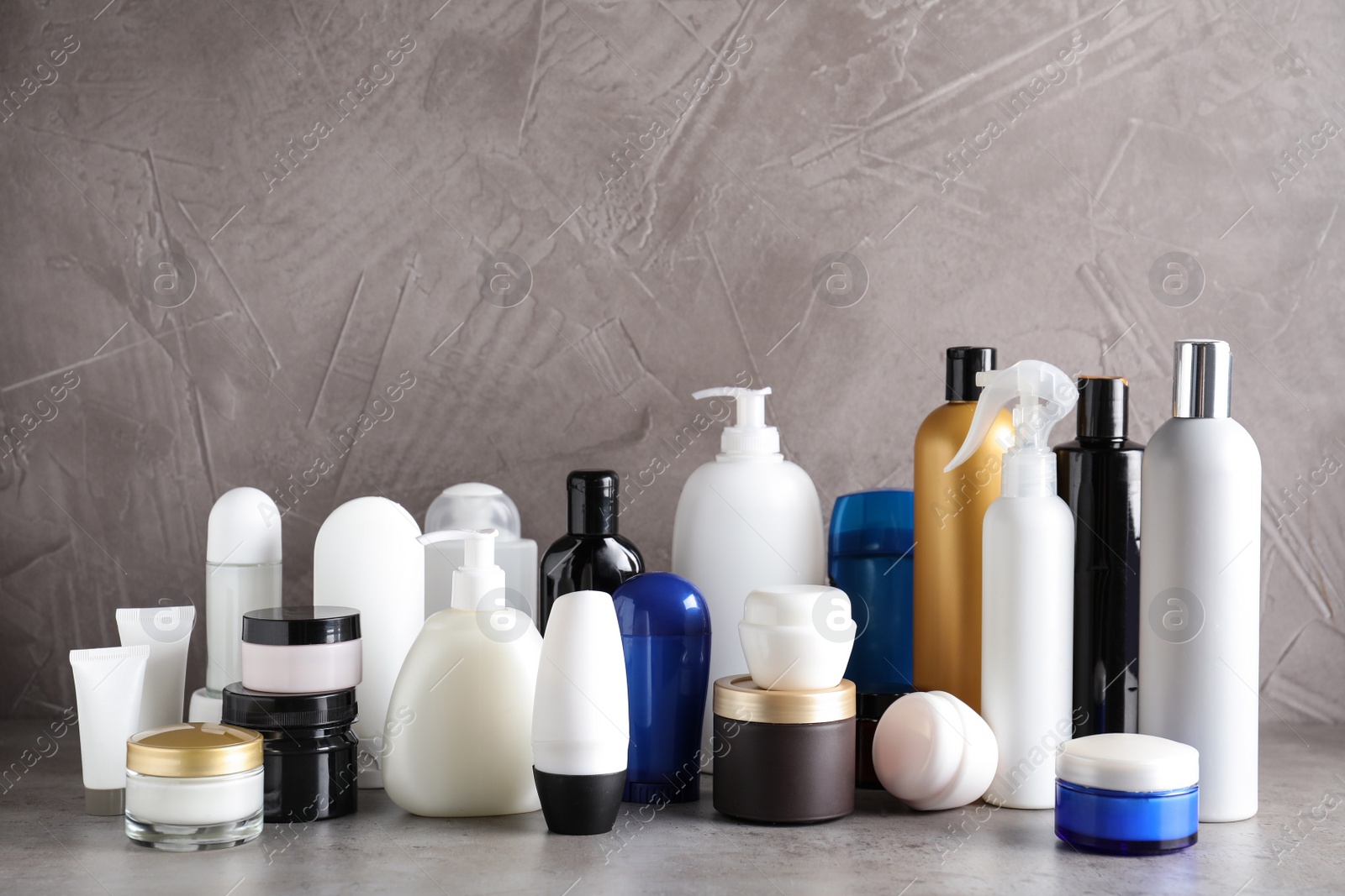 Photo of Different body care products on table against grey background