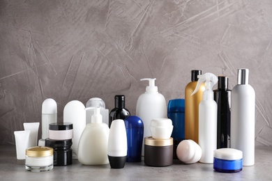 Photo of Different body care products on table against grey background