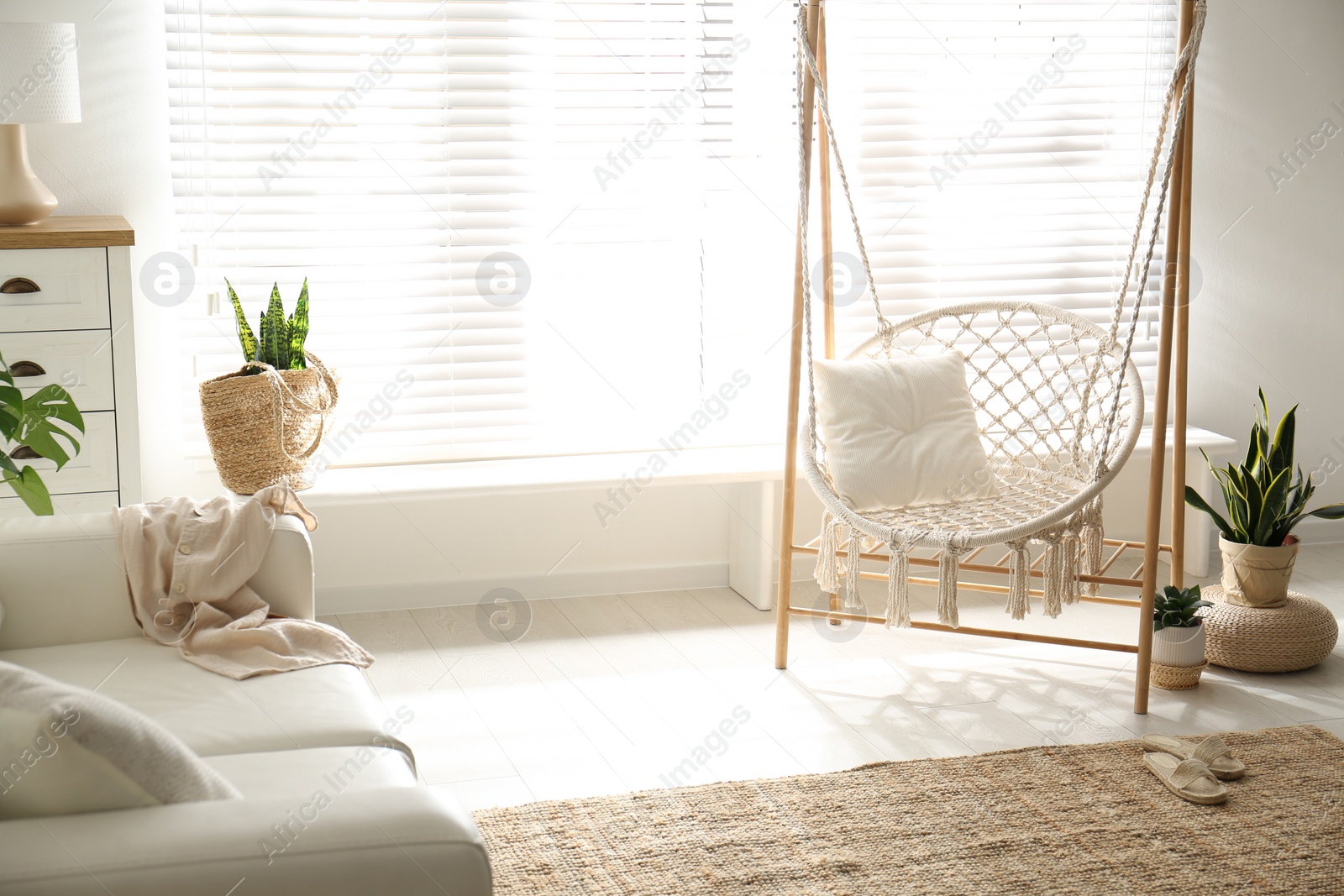Photo of Comfortable hammock chair in stylish room. Home interior