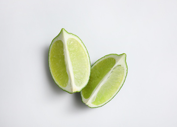 Photo of Cut fresh juicy lime on white background, top view