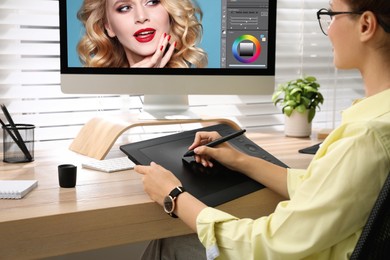 Photo of Professional retoucher working on graphic tablet at desk, closeup