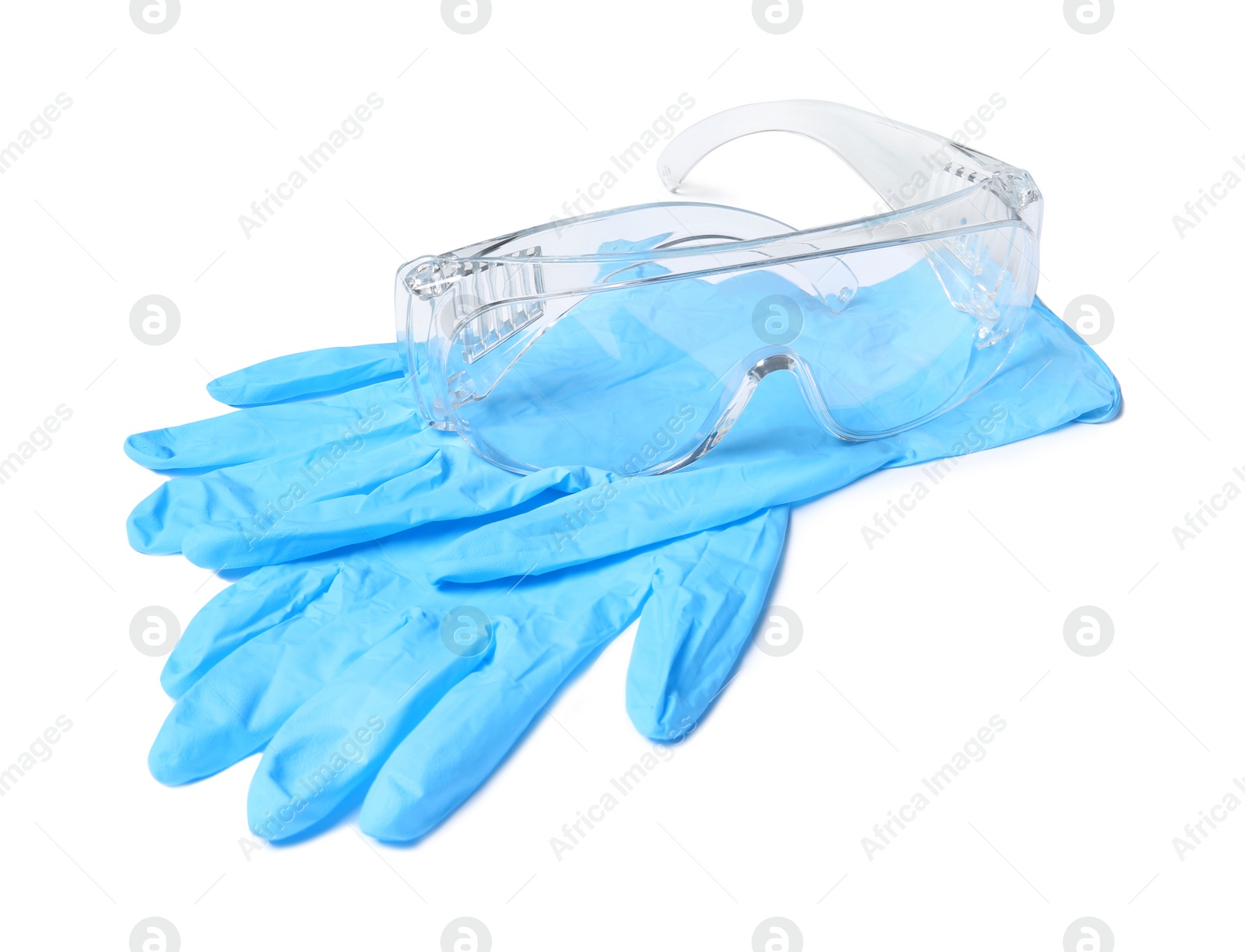 Photo of Medical gloves and safety glasses on white background