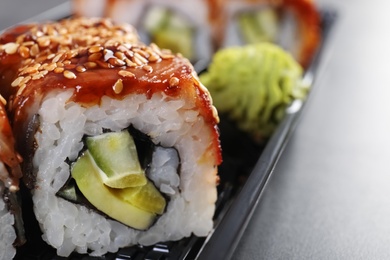 Fresh tasty sushi rolls on table, closeup with space for text. Food delivery service