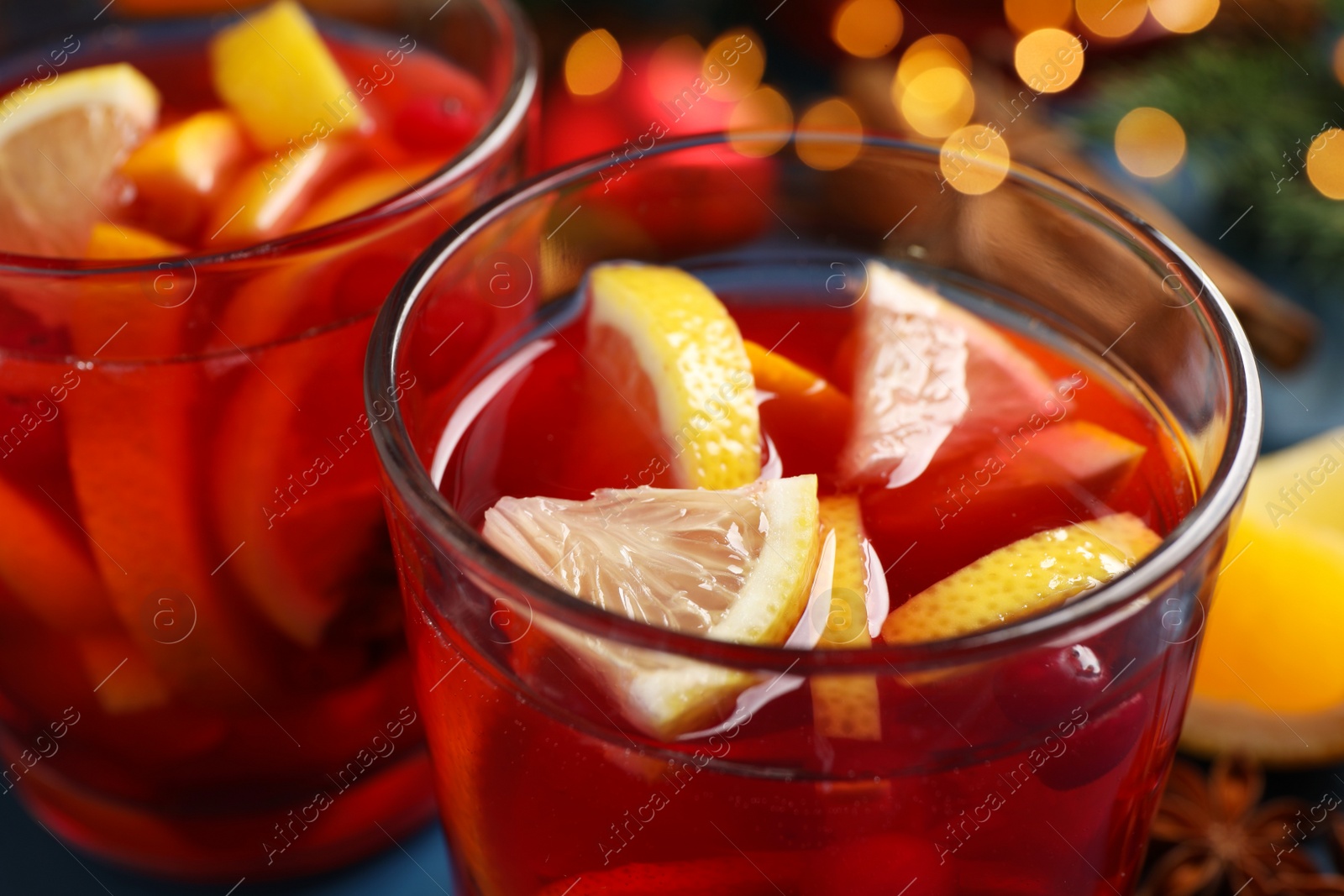 Photo of Glass with delicious punch drink on table, closeup