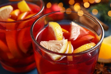 Photo of Glass with delicious punch drink on table, closeup